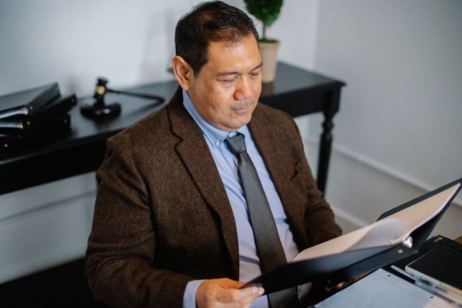 Person in an office closely reviewing a legal notice document