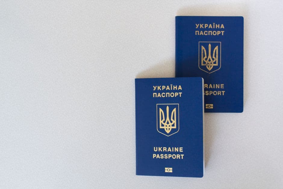 Two government-issued passports placed close together on a plain surface, representing the identity documents Amazon requests during seller verification.