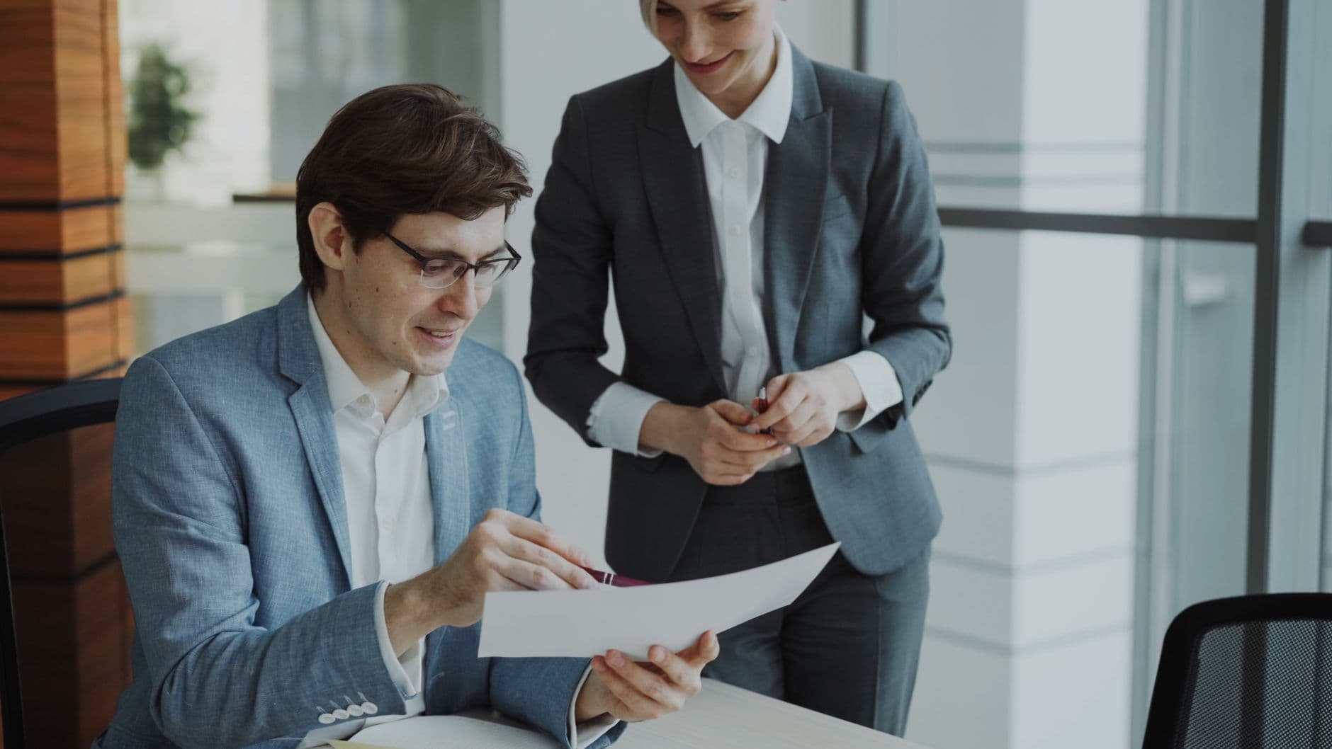 Two people reviewing an Amazon suspension notice and supporting documents together